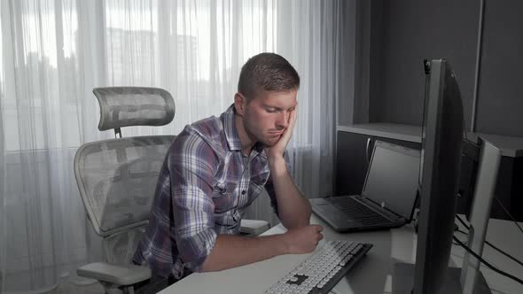 Handsome Man Falling Asleep in Front of His Computer