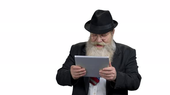 Funny Elderly Businessman Playing on Digital Tablet