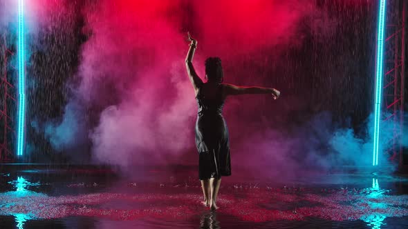 A Passionate Performance of Spanish Flamenco Dance in the Rain. A Charming Young Woman Dances on the