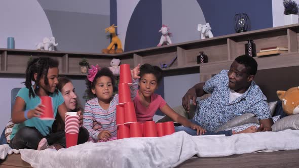 Mixed Race Family Playing on Bed During Quarantine