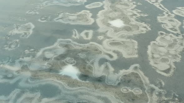 Beautiful flight in the afternoon over a frozen river, lake, ocean. Ice everywhere. Snow on ice.