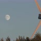 The Windmill Is Spinning Against the Moon in the Blue Sky - VideoHive Item for Sale