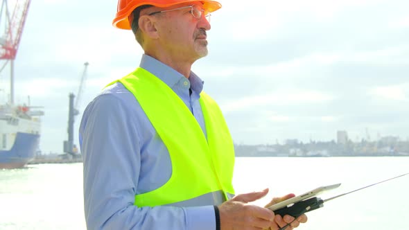 Port Worker at Construction Engineer Controls Vessel Repair