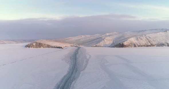 Drone Rises Descends Over Trail Left by a Boat on the Ice of a Frozen Lake