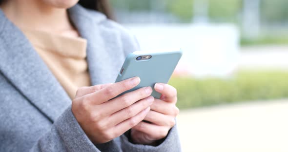 Woman use of mobile phone in city