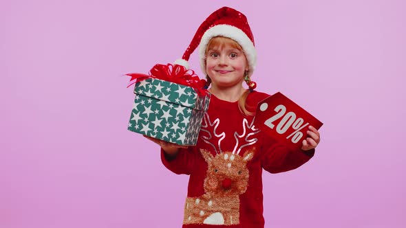 Toddler Girl in Christmas Hat Showing Gift Box and 20 Percent Discount Inscriptions Banner Text Note