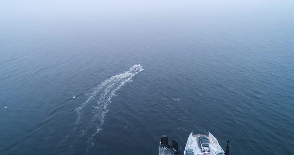 Aerial shot of a speeding boat near the harbor