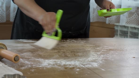 Womens Hands Wiping Flour From Table, Remove Sugar and Cinnamon with Brush
