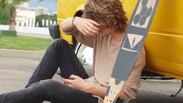 Hipster Guy Sitting Next His Yellow Car During Road Trip