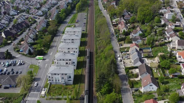 A train is riding across the residential district. 