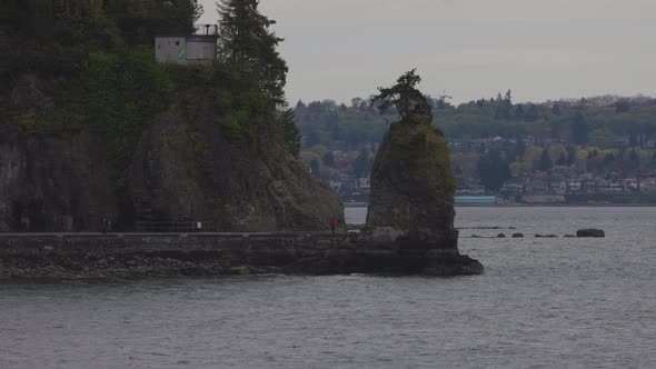 Siwash Rock and Seawall in Stanley Park on the West Coast of Pacific Ocean