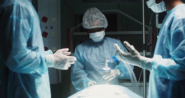 A Team of Surgeons Perform an Operation in a Bright Operating Room