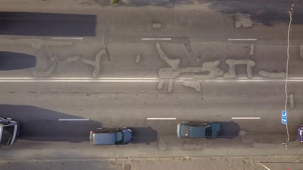 Aerial top down view of busy city street with traffic cars during rush hour.