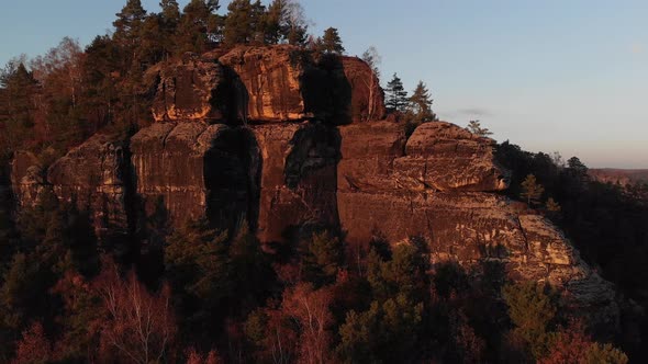 AERIAL: Flying up the sandstone mountain in Saxon Switzerland during sunset