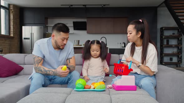 Asian Parent Playing Educational Game with Baby Daughter