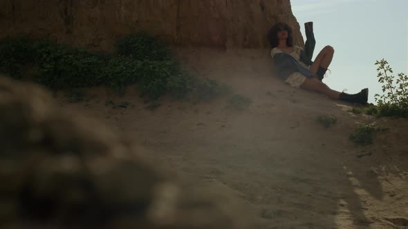 Relaxed Woman Leaning Sand Cliff Relaxing on Seashore