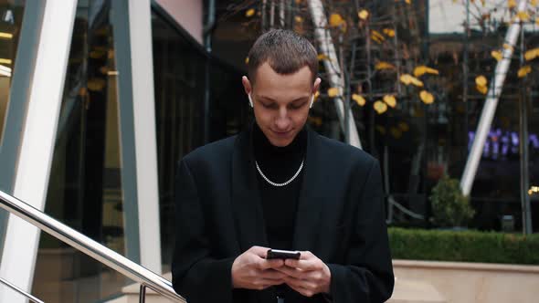 Handsome Caucasian Man Using Mobile Phone, Texting Messages, Cheating on His Smartphone While