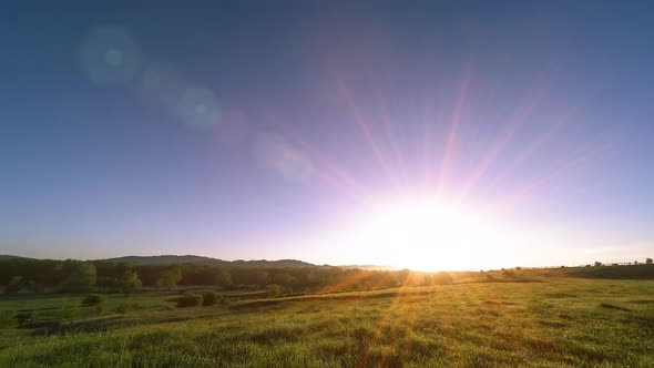  UHD Mountain Meadow Timelapse at the Summer. Clouds, Trees, Green Grass and Sun Rays Movement.