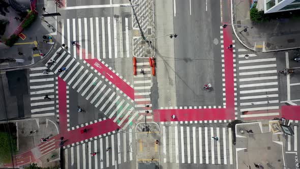 Pedestrian walking in crosswalk at famous Intersection of Sao Paulo.