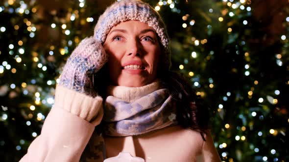 Happy Woman Calling on Smartphone on Christmas