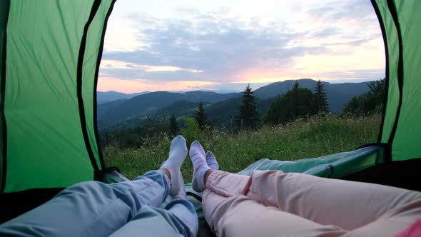 Couple in love resting in a tent in the mountains.