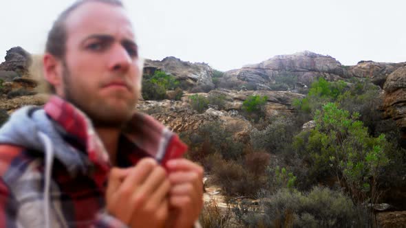 Man shaking his hand on top of mountain 4k