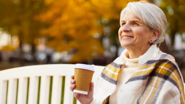 Senior Woman Drinking Coffee in Autumn Park 36