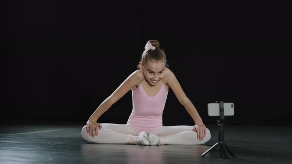 Little Girl 12s Year Old Child Teenager Ballerina Gymnast Acrobat Sit on Floor in Butterfly Pose