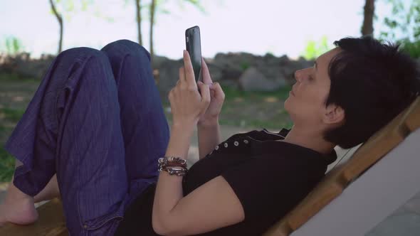 Woman Texting Message on the Street.