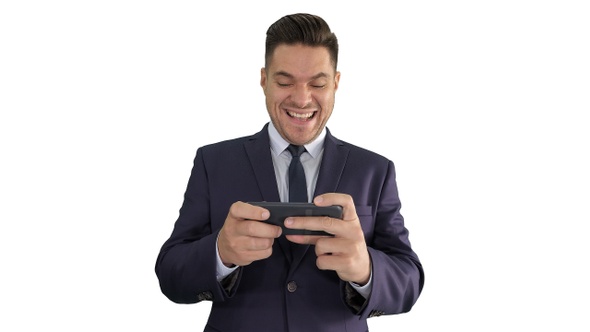 Funny businessman playing in game on the phone and winning