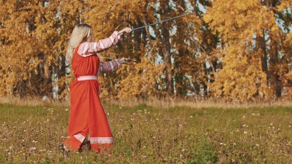 Medieval Concept - Woman in Red National Dress Training on the Field - Masterfully Wields Swords -