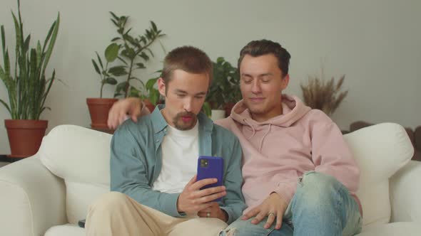 Two Young Attractive Lgbt Men Finish a Conversation with Their Friends on the Video Call They Both