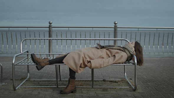 Woman Is Lying On A Bench