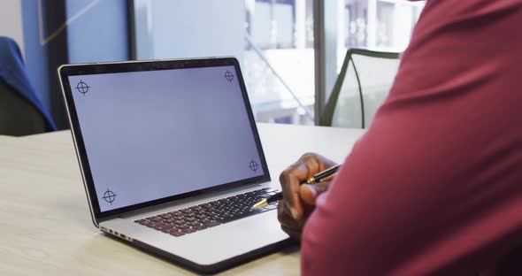 Video of african american man working on laptop with copy space on screen