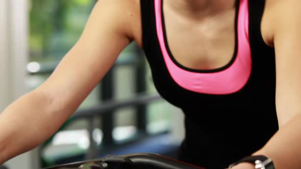 Fit woman using exercise bike