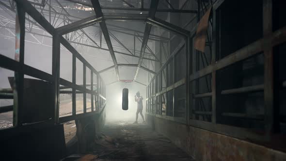 4K Asian woman boxer do boxing exercise with punching bag in abandoned building.