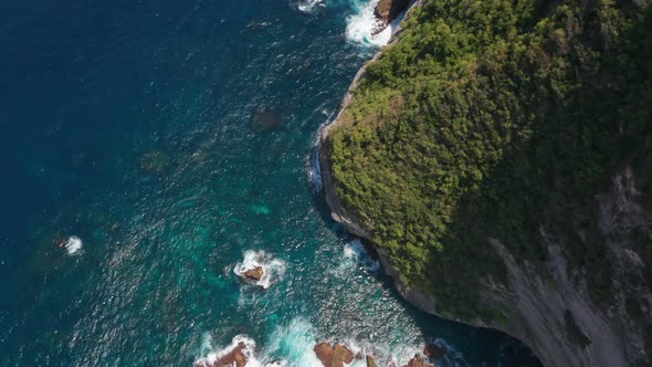 Bird's Eye View of Sparkling Blue Waters in Nusa Penida Islands, Bali Right By a Rocky Cliff