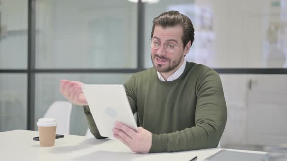 Young Businessman Making Video Call on Tablet in Office