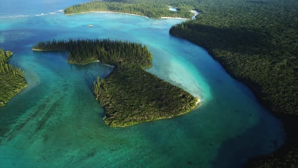 Slow aerial tilt up revealing horizon, small islands of Oro Bay, Isle of Pines.