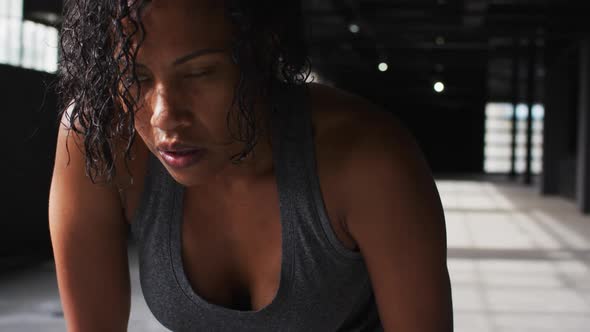 Portrait of african american woman taking a break breathing heavily and looking at the camera