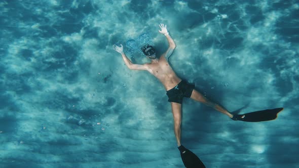 Young Boy Does Freediving Apnea Underwater Circular Bubbles in the Ocean