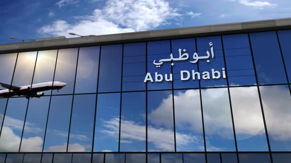 Airplane landing at Abu Dhabi United Arab Emirates airport mirrored in terminal