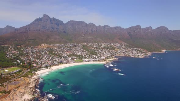 Aerial travel drone view of Camps Bay beach, Cape Town, South Africa.