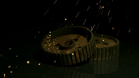 Sparks with gears in ultra slow motion 1500fps on a reflective surface - SPARKS w GEARS 
