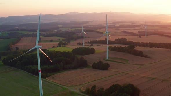 Wind Turbines Generate Energy Against Distant Mountains