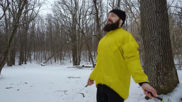 Bearded Sports Man Jumping with Skipping Rope in Winter Forest