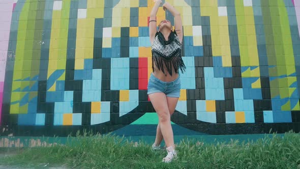 Dancing Female. happy mixed race woman dancing performance with long dreadlocks in shorts.