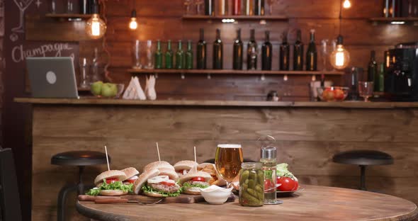 Fresh Homemade Burgers Are Ready on a Restaurant Table in Front of the Bar