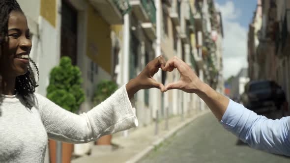 Cheerful Multiethnic Couple Standing on Street Outdoors