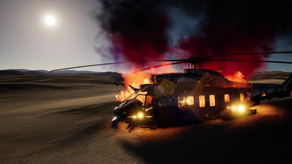 Burned Military Helicopter in the Desert at Sunset